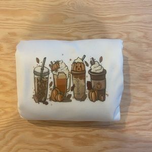 Brand new Crewneck for the fall! Never worn! White Crewneck with latte designs!